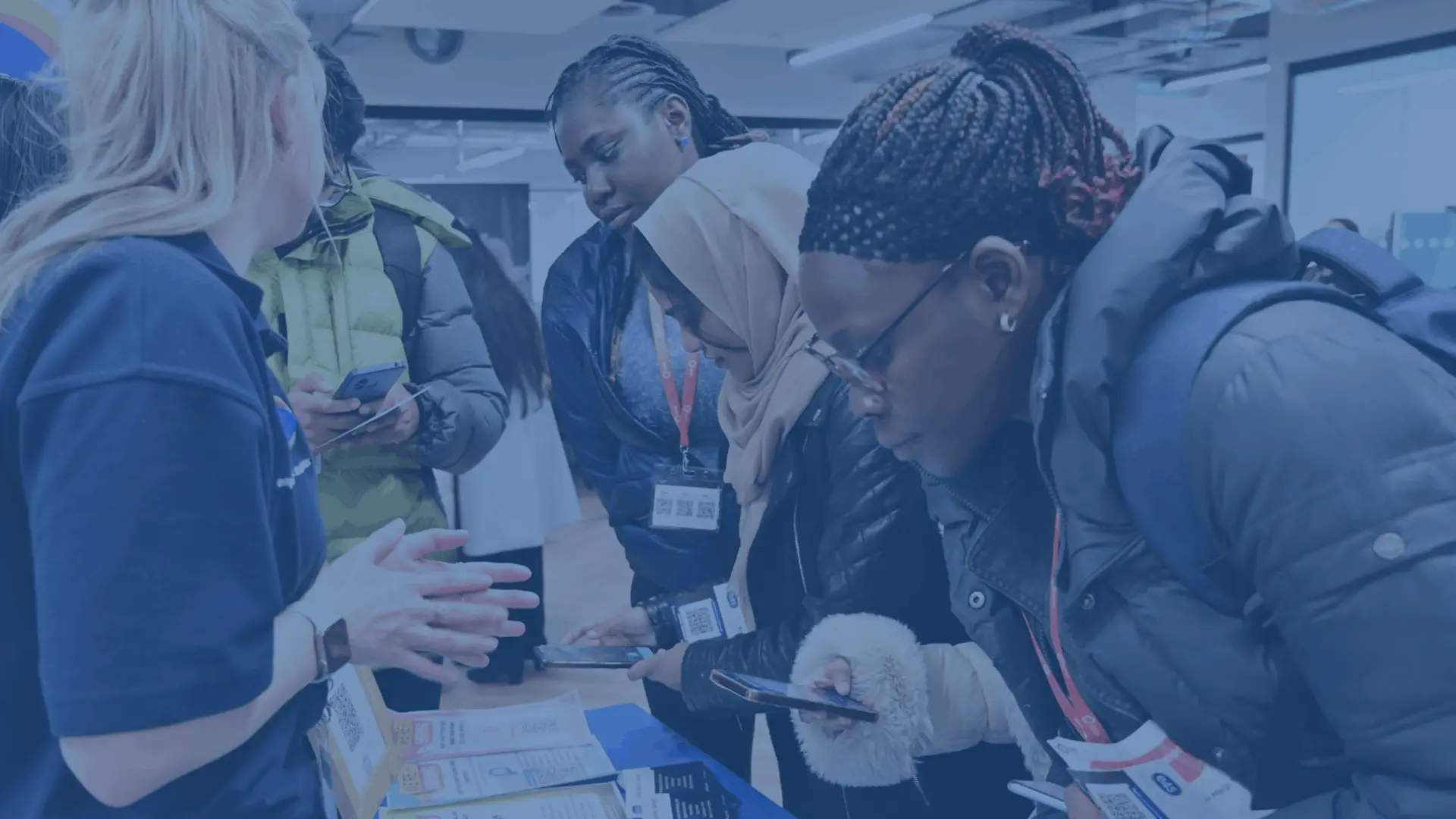 Students registering to receive student jobs at a stand at a careers fair