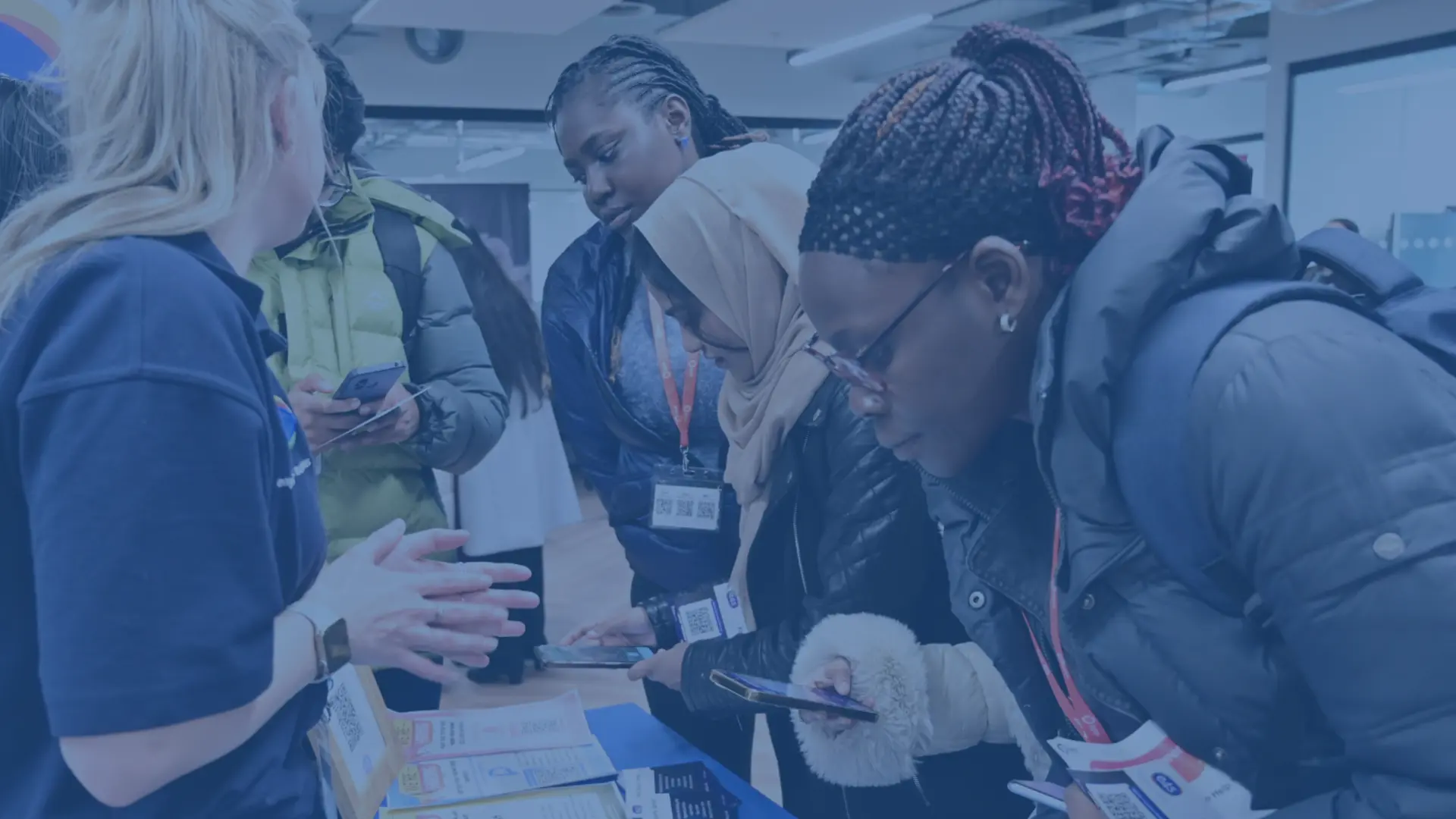 Students registering to receive student jobs at a stand at a careers fair