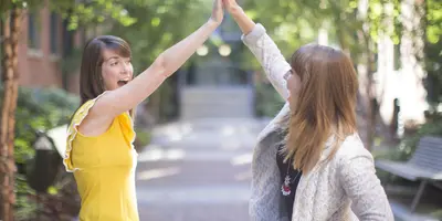 Two girls high-fiving