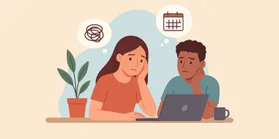Two young people stare at a laptop, worrying about work.