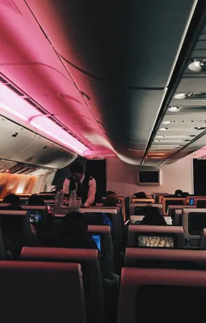 An interior view of an airplane cabin with passengers seated,